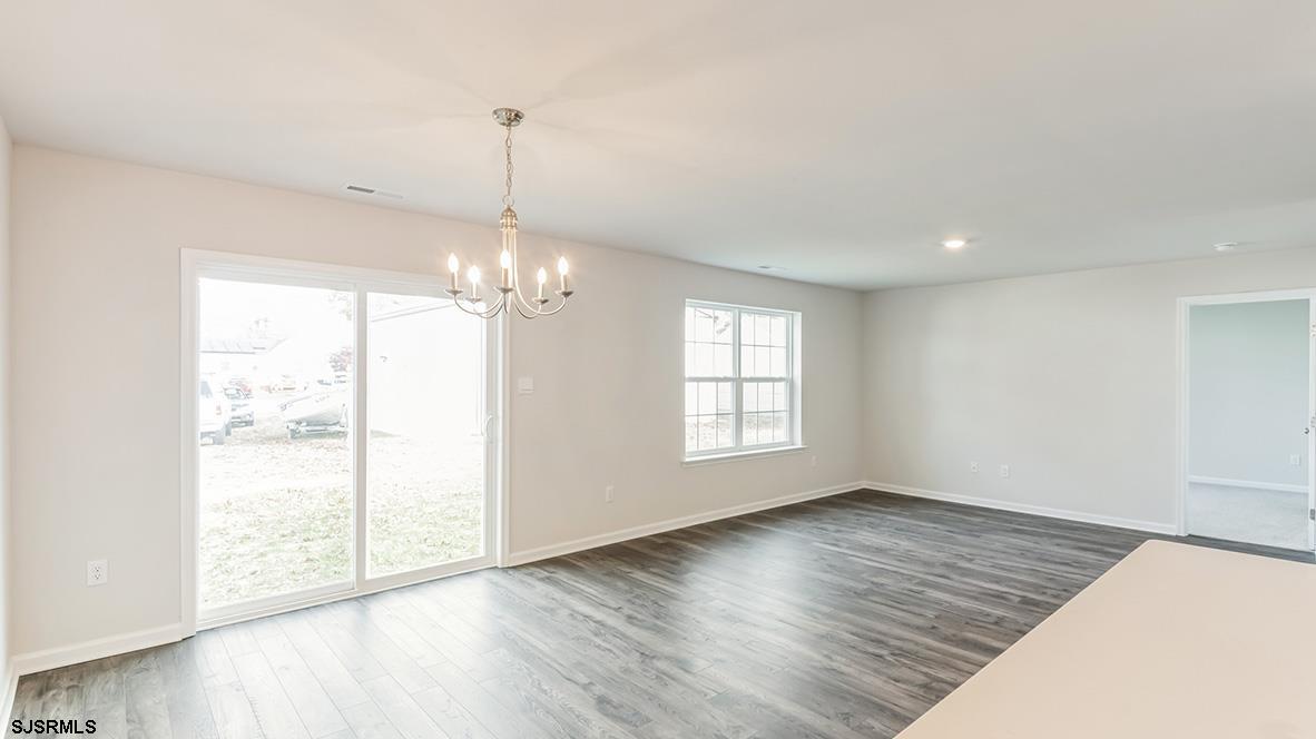 103 West Drumbed Road Villas, NJ 08251 - Photo 19 of 23 a view of an empty room with wooden floor and a window