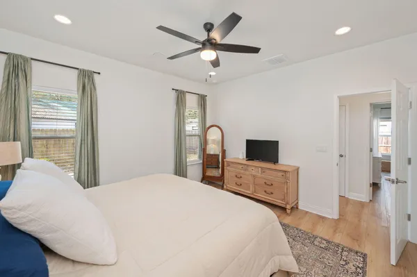 a bedroom with a large bed and a flat tv screen