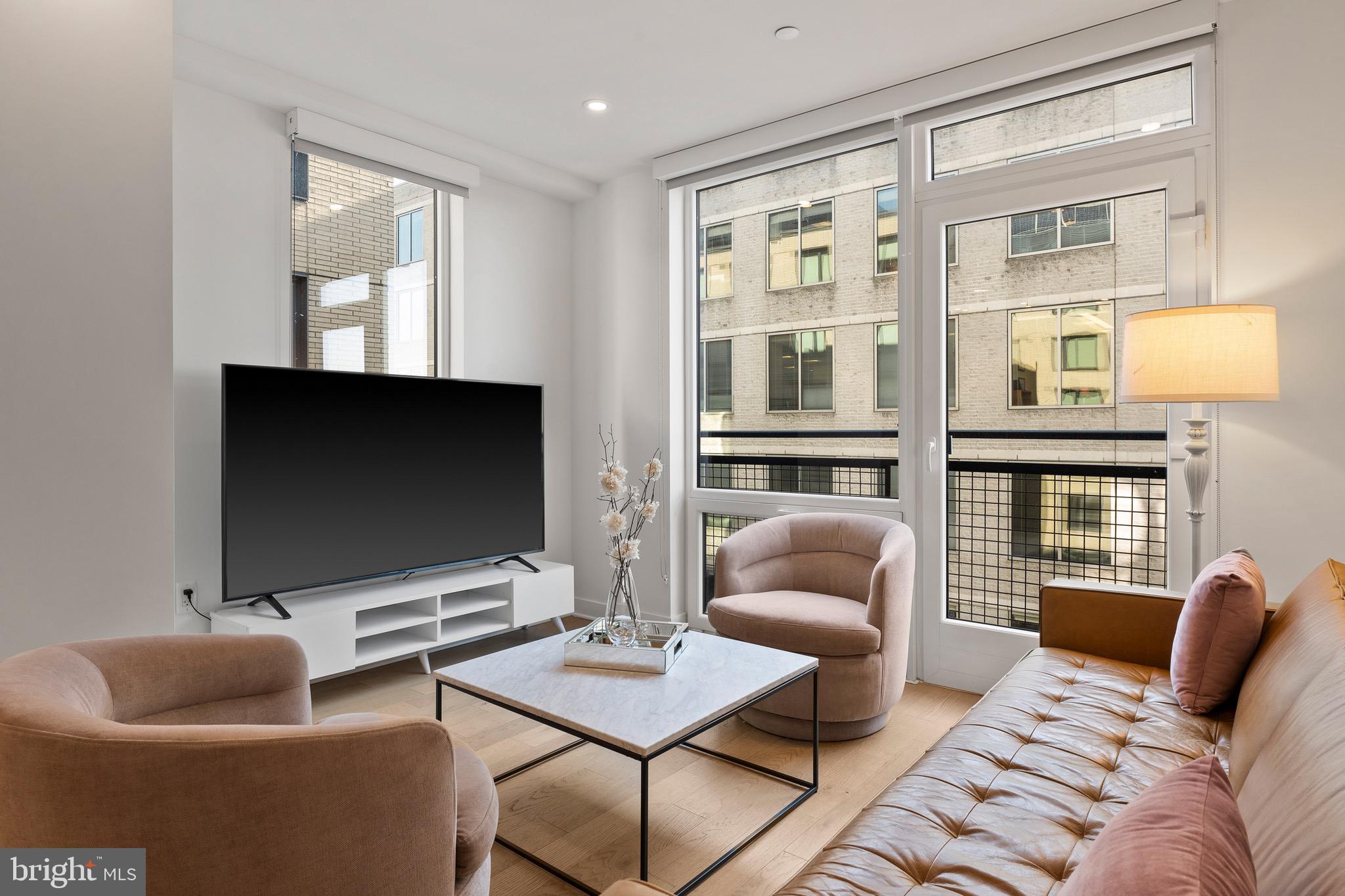 37 L Street Southeast, Unit 908 Washington, DC 20003 - Photo 3 of 20 a living room with furniture and a flat screen tv