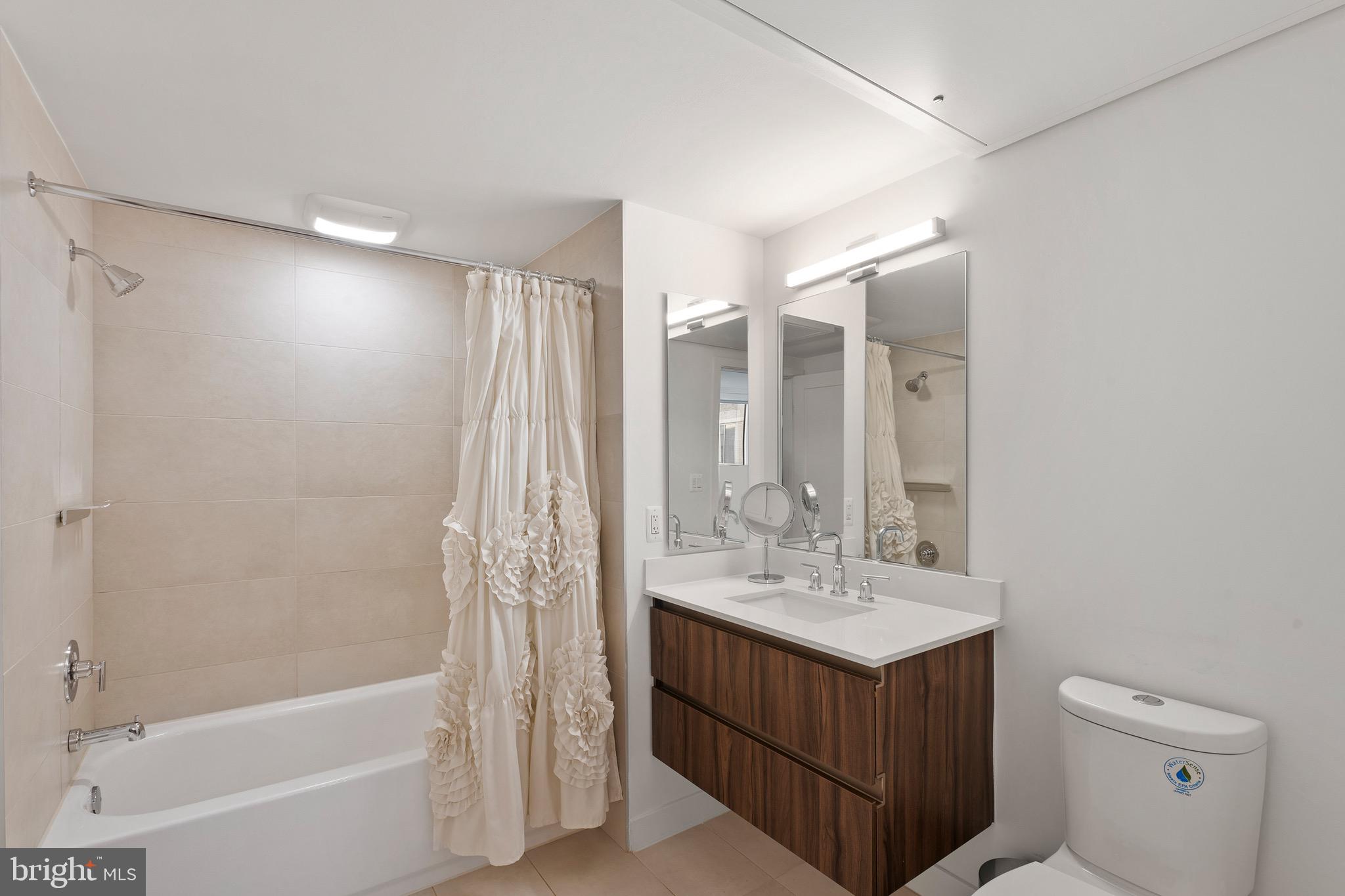 37 L Street Southeast, Unit 908 Washington, DC 20003 - Photo 4 of 20 a bathroom with a sink double vanity mirror and a bathtub
