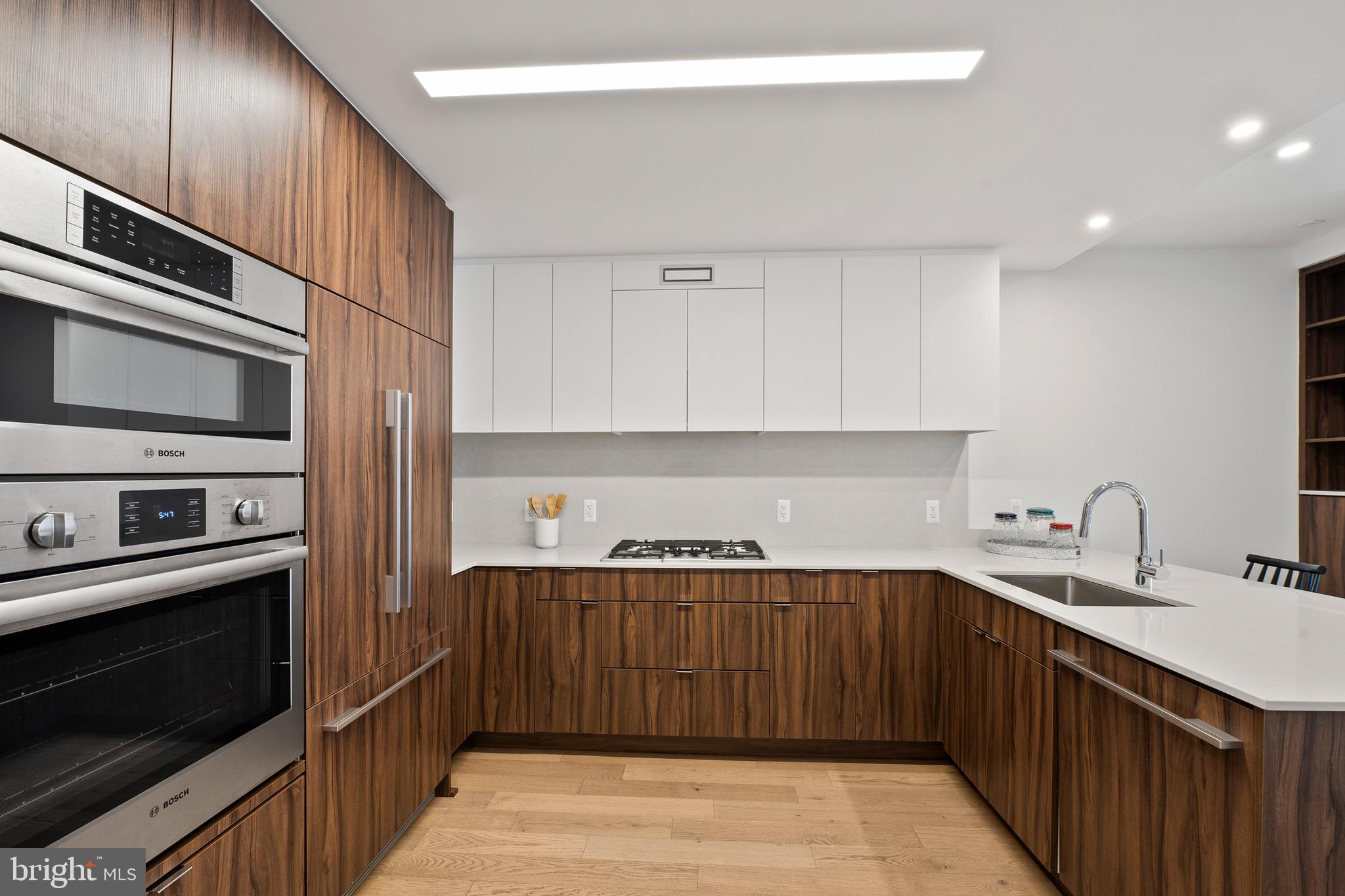 37 L Street Southeast, Unit 908 Washington, DC 20003 - Photo 6 of 20 a kitchen with stainless steel appliances a sink stove and cabinets