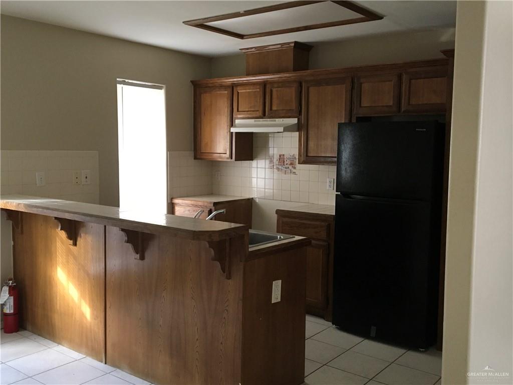 2002 Angus Street Mission, TX 78572 - Photo 4 of 9 a kitchen with a refrigerator and a sink
