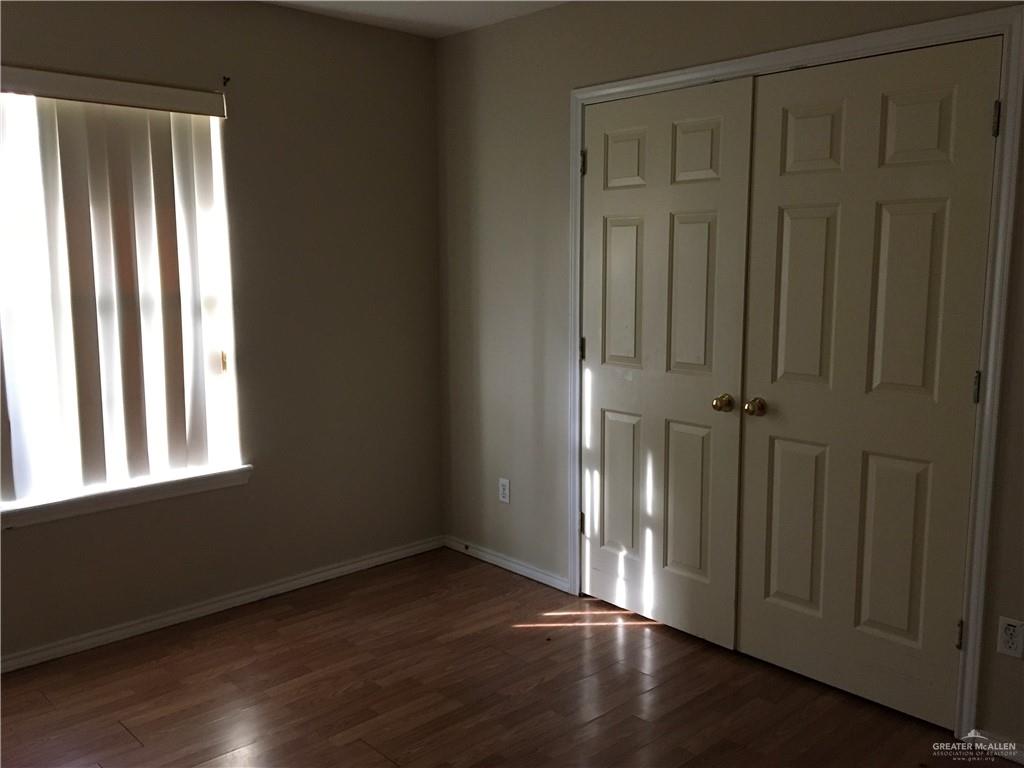 2002 Angus Street Mission, TX 78572 - Photo 7 of 9 an empty room with wooden floor and windows