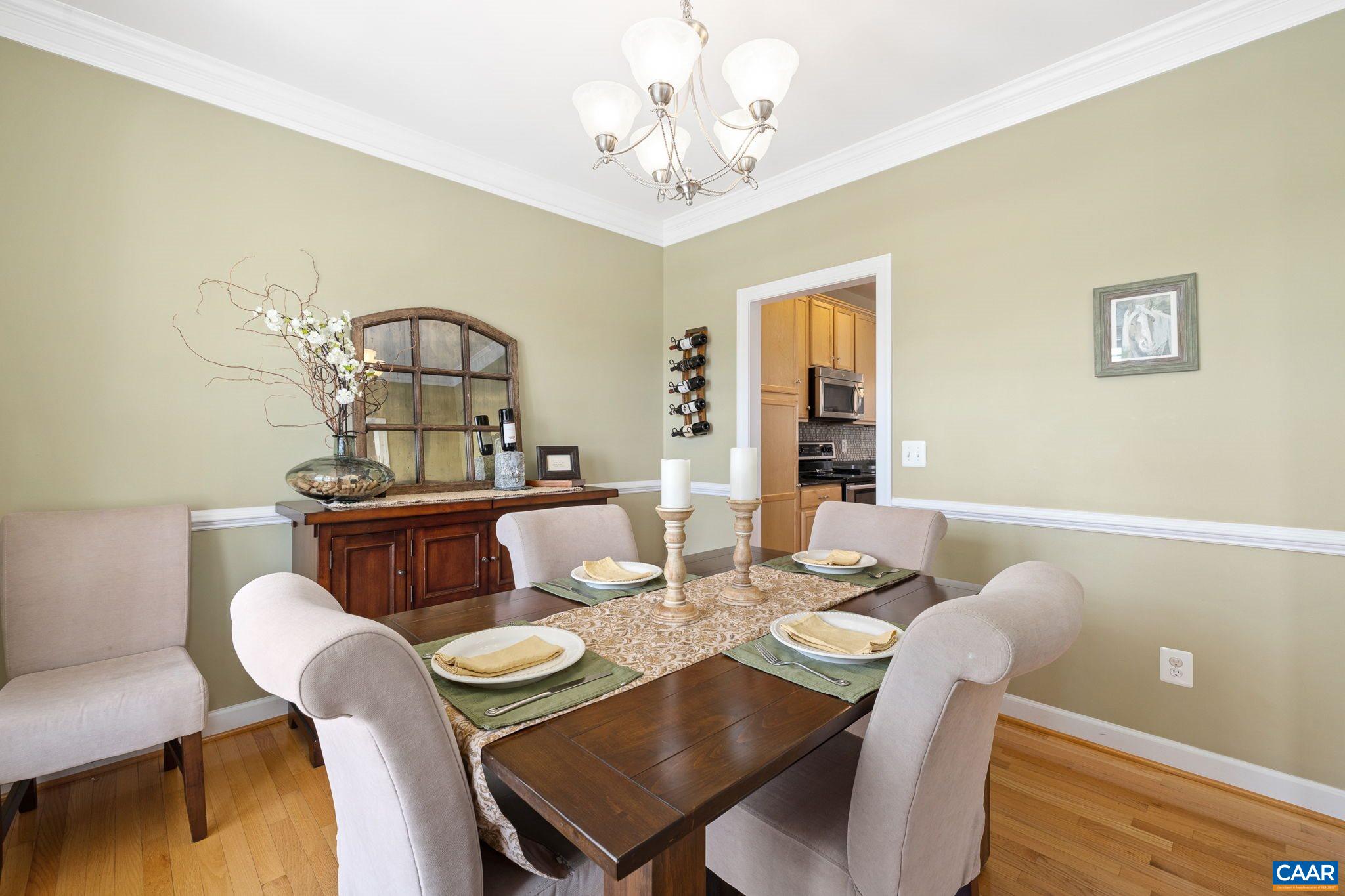 212 Wexford Ridge Road Ruckersville, VA 22968 - Photo 21 of 73 a view of a dining room with furniture a chandelier and wooden floor