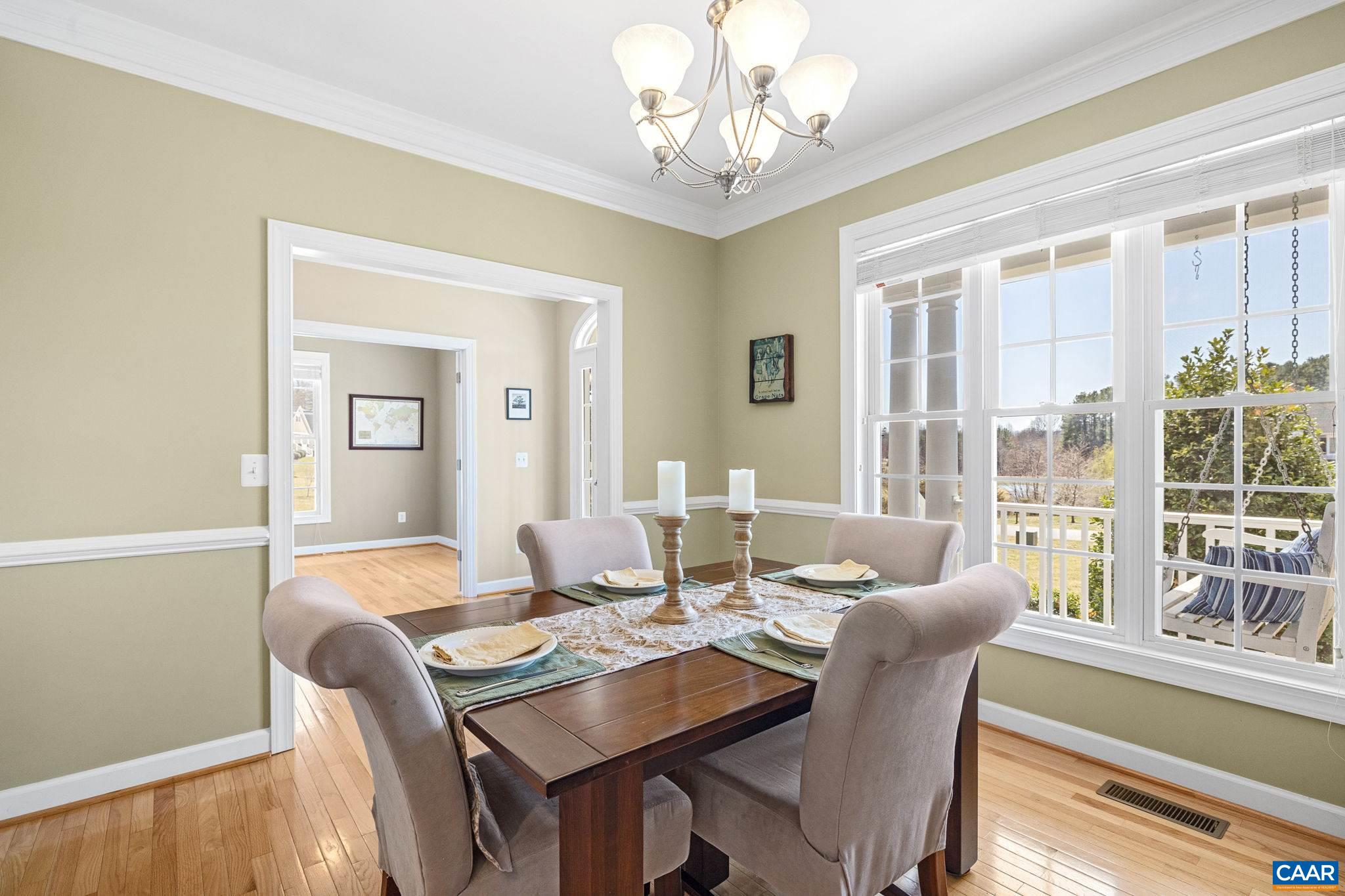 212 Wexford Ridge Road Ruckersville, VA 22968 - Photo 23 of 73 a dining room with furniture a large window and wooden floor
