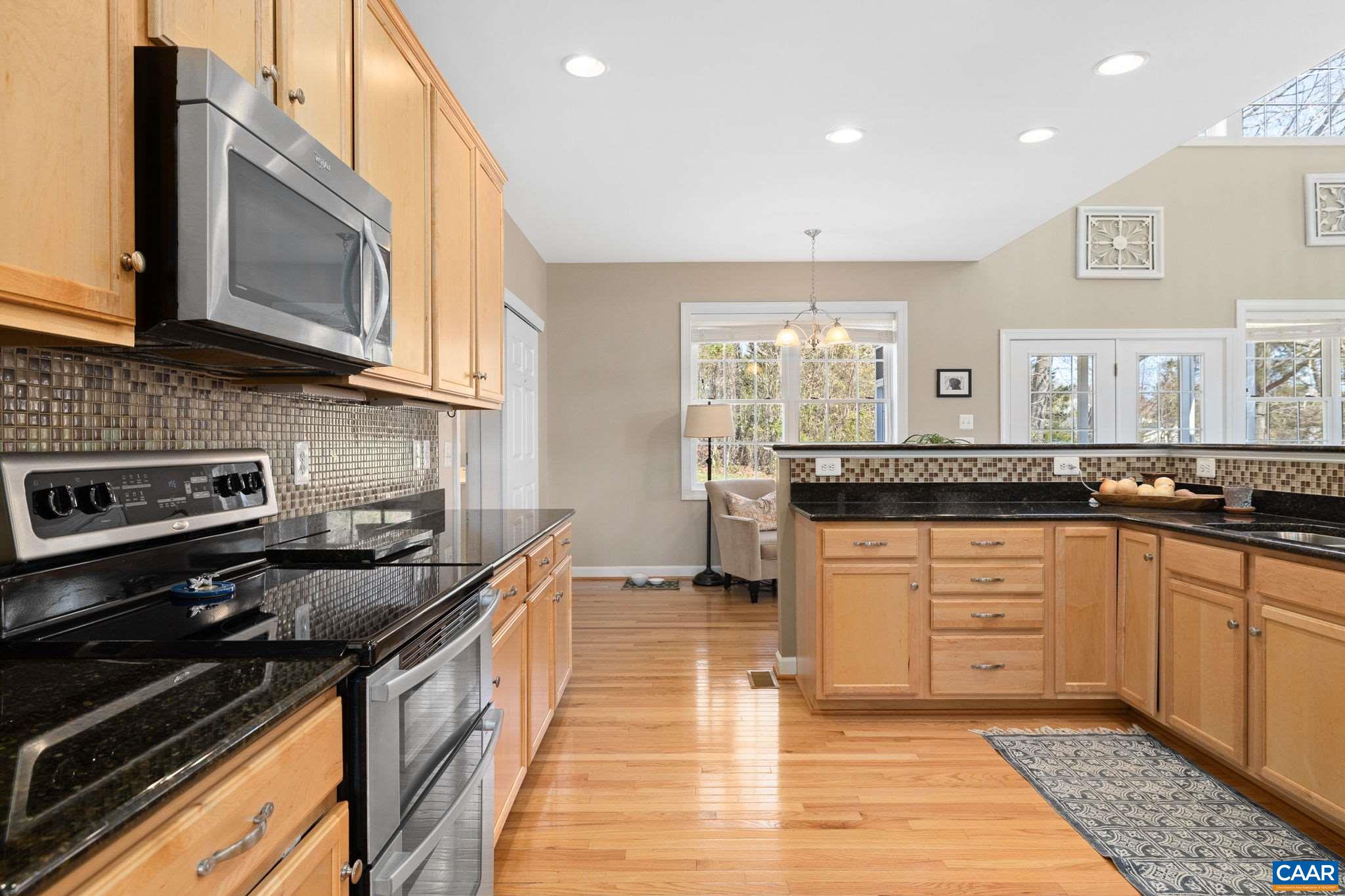 212 Wexford Ridge Road Ruckersville, VA 22968 - Photo 24 of 73 a kitchen with stainless steel appliances granite countertop a stove a sink and a microwave