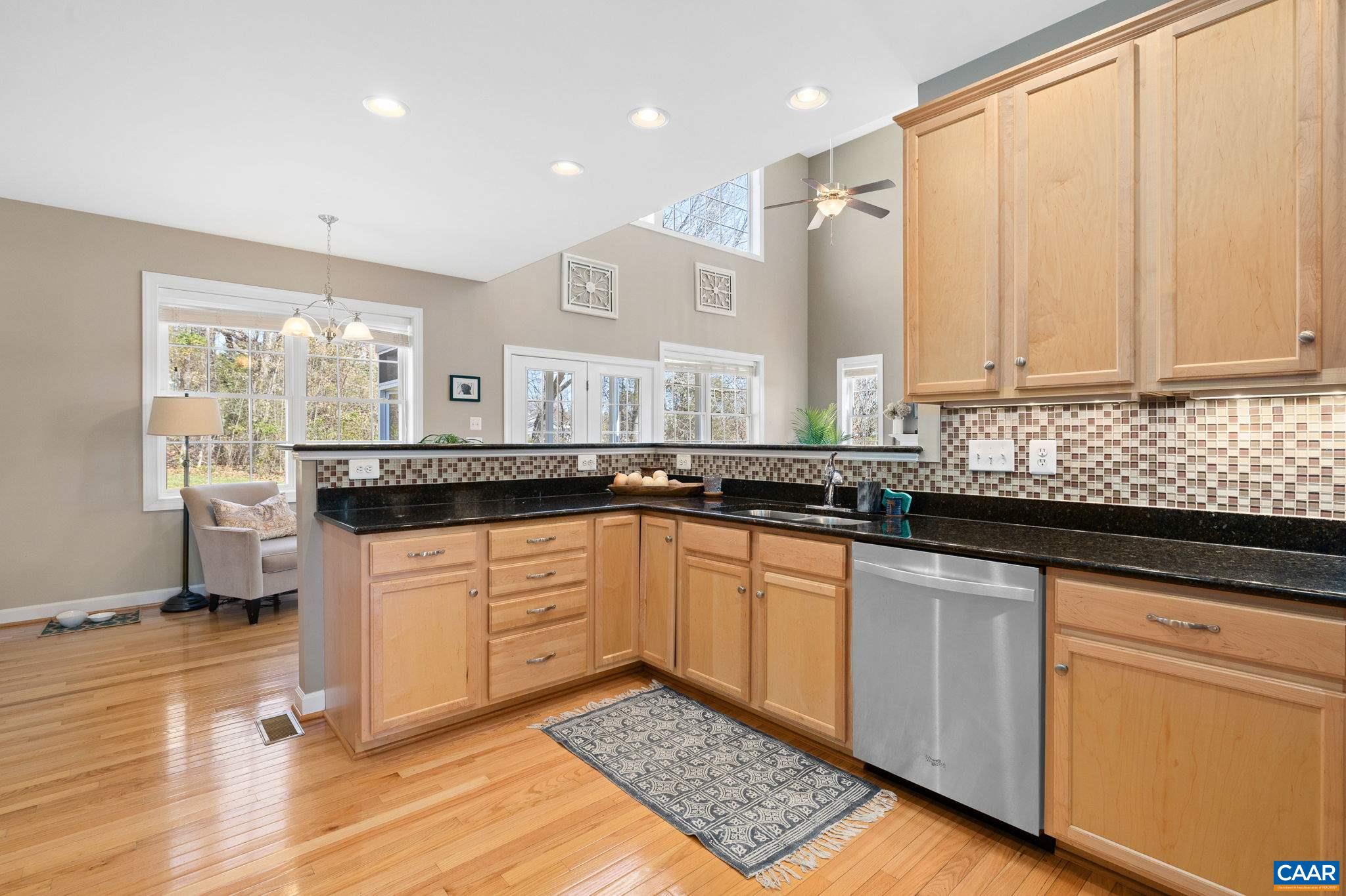 212 Wexford Ridge Road Ruckersville, VA 22968 - Photo 25 of 73 a kitchen with granite countertop a sink stainless steel appliances and cabinets