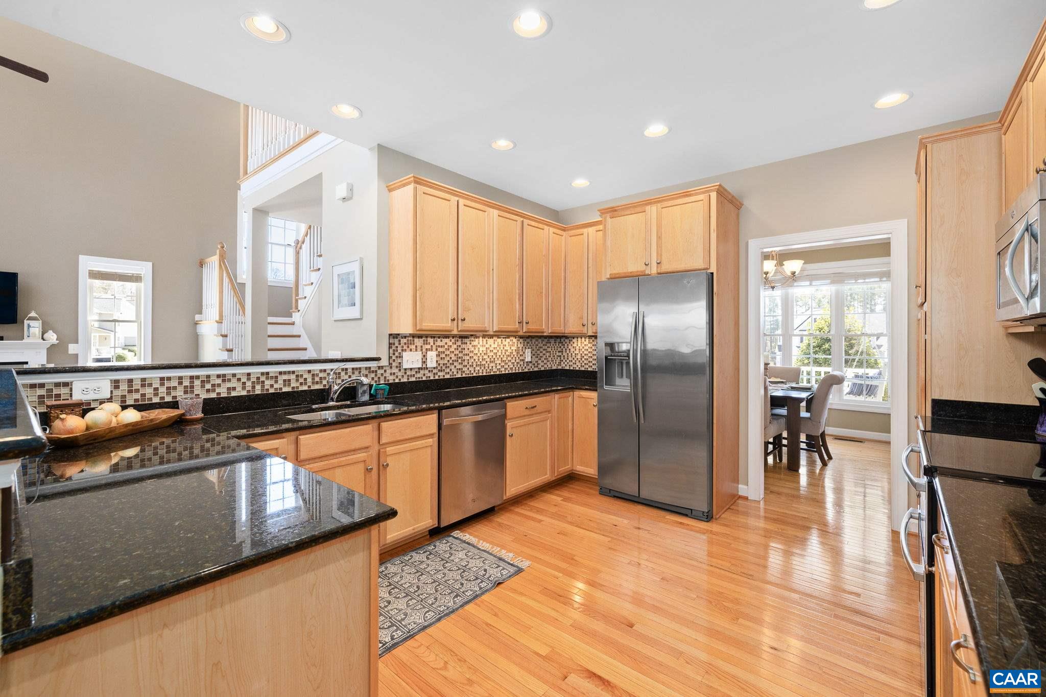212 Wexford Ridge Road Ruckersville, VA 22968 - Photo 27 of 73 a kitchen with stainless steel appliances granite countertop a refrigerator a sink a stove and oven with wooden floor