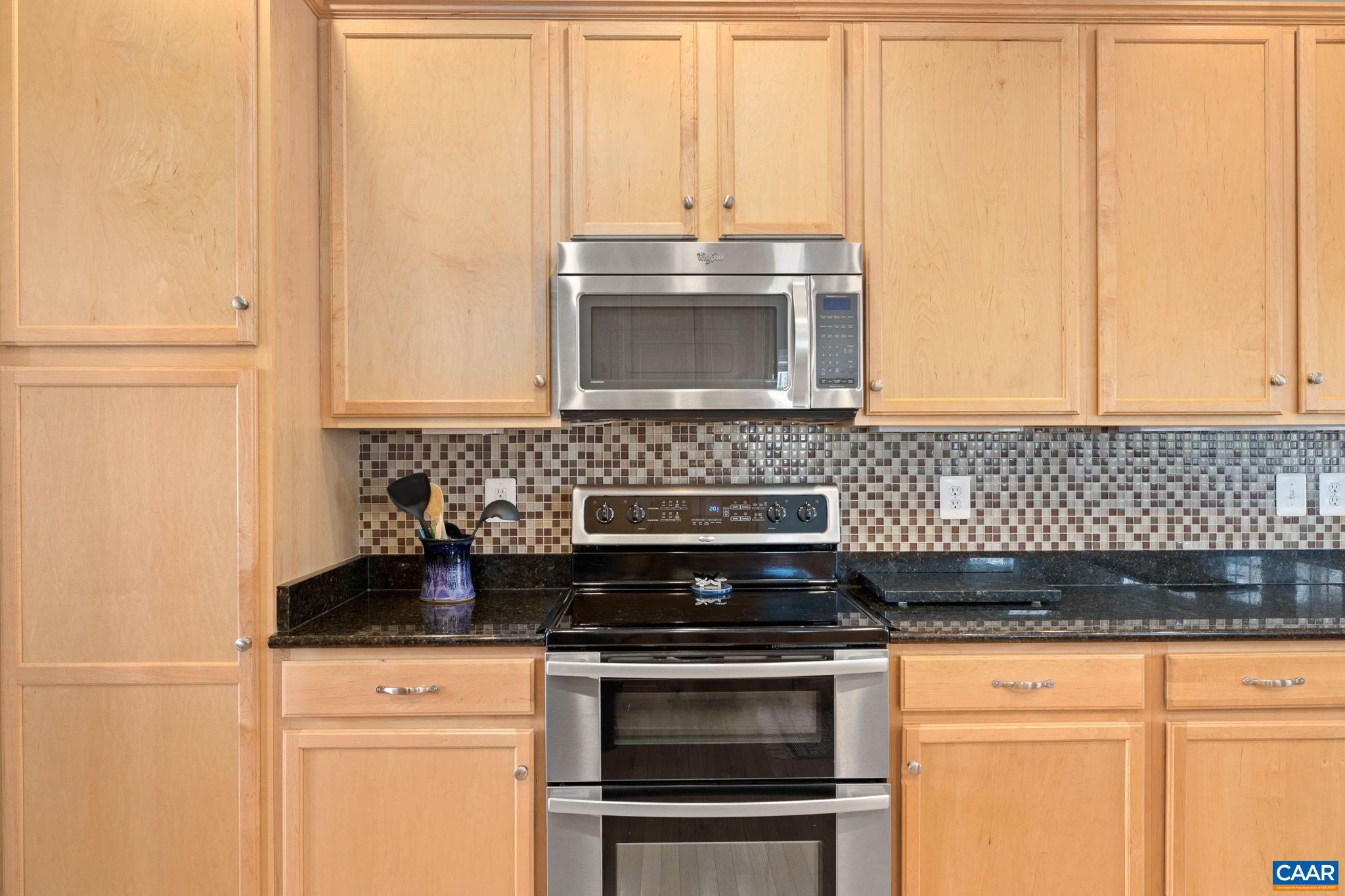 212 Wexford Ridge Road Ruckersville, VA 22968 - Photo 29 of 73 a kitchen with granite countertop white cabinets and stainless steel appliances