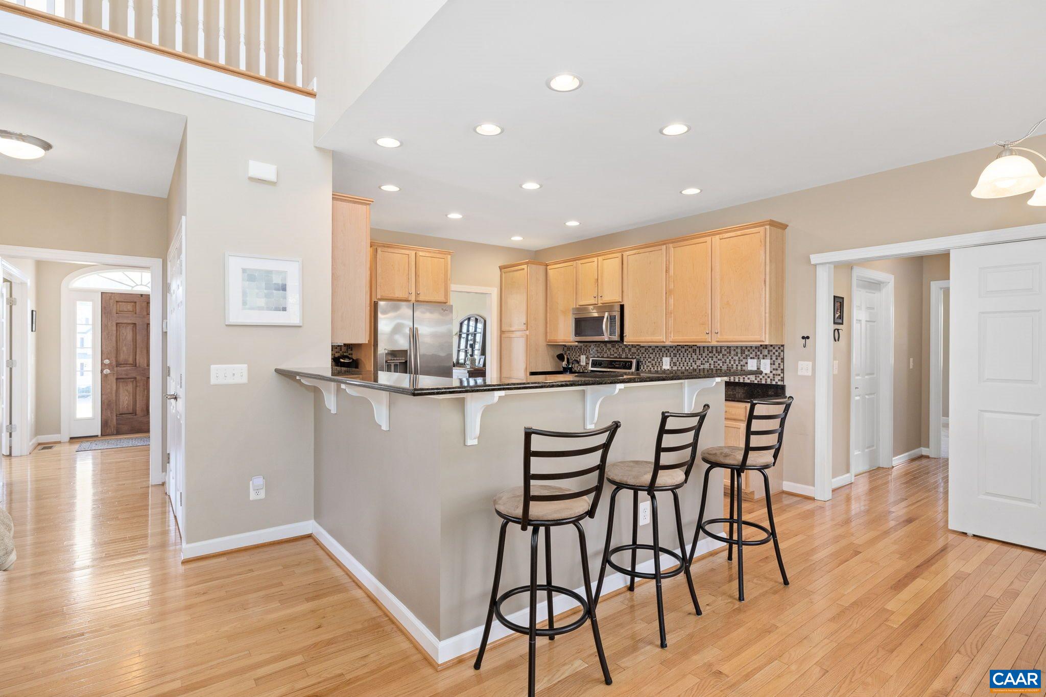 212 Wexford Ridge Road Ruckersville, VA 22968 - Photo 33 of 73 a kitchen with stainless steel appliances granite countertop a refrigerator and a stove top oven