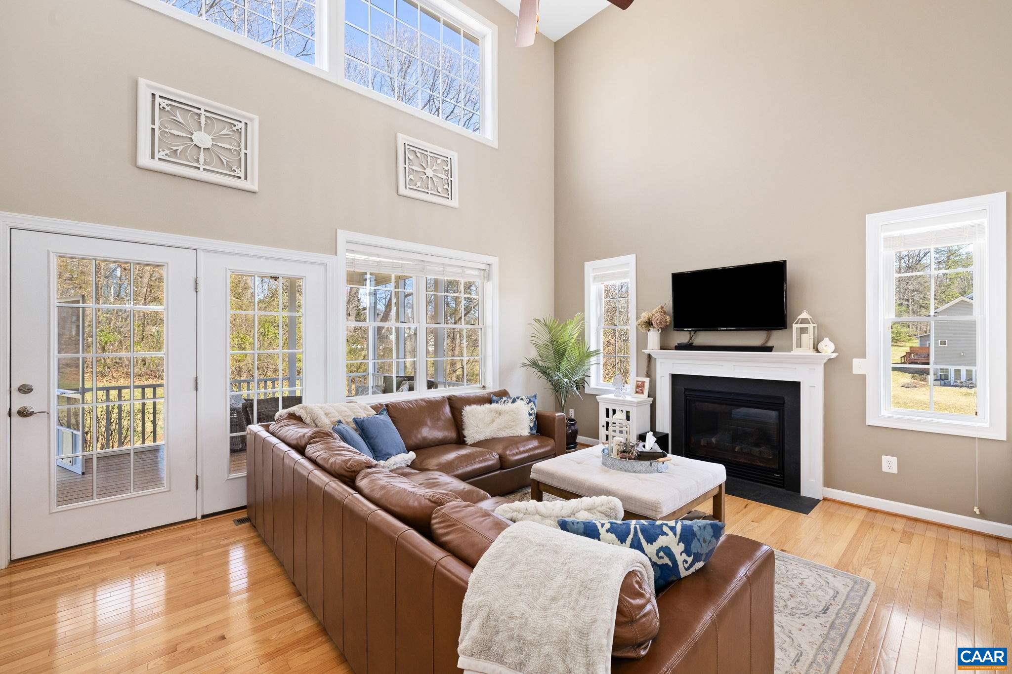 212 Wexford Ridge Road Ruckersville, VA 22968 - Photo 36 of 73 a living room with furniture a fireplace and a flat screen tv