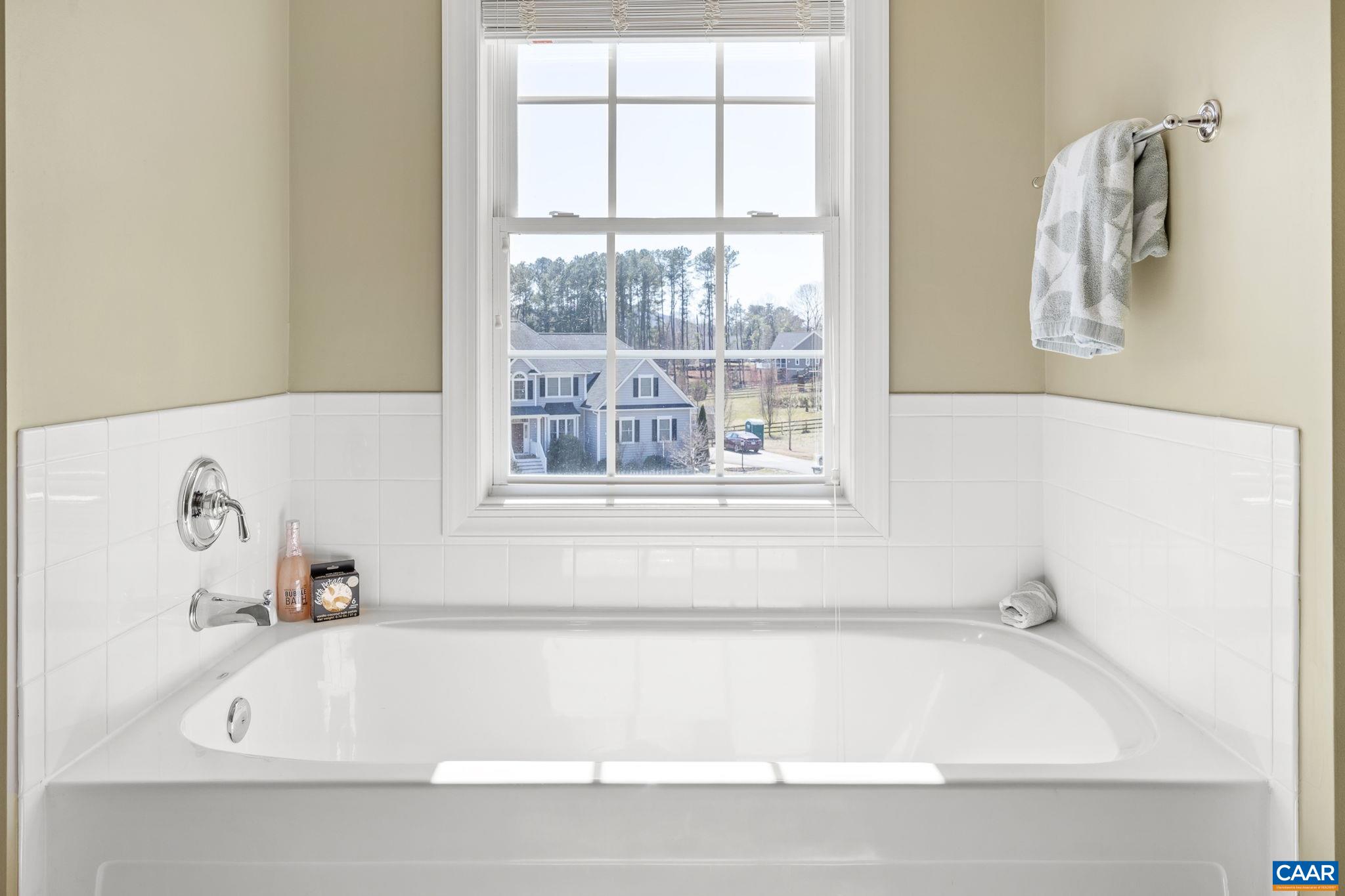 212 Wexford Ridge Road Ruckersville, VA 22968 - Photo 58 of 73 a white bath tub sitting in a bathroom next to a window