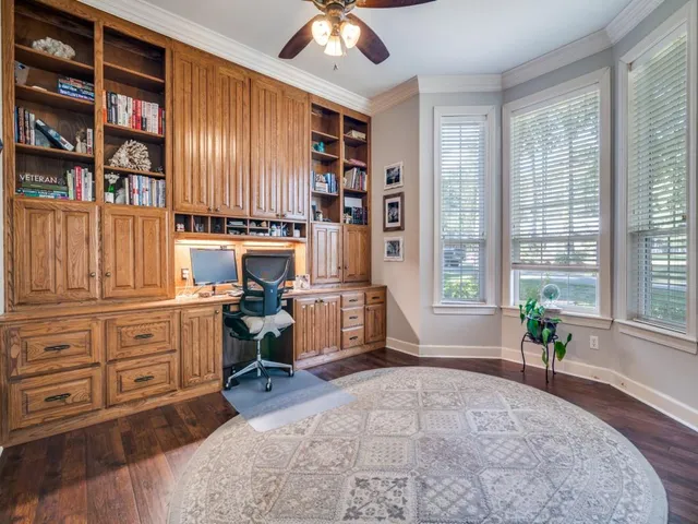 a room with a bed and a book shelf
