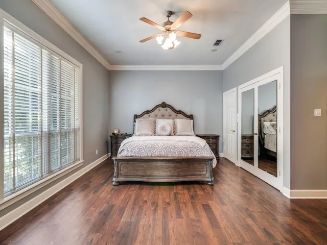 a bedroom with a bed and a large window