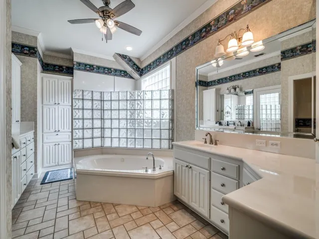 a bathroom with a bathtub a toilet a sink and a large mirror