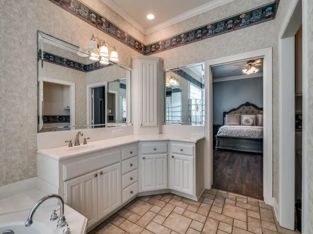 a en suite bathroom with a sink a large mirror and a shower