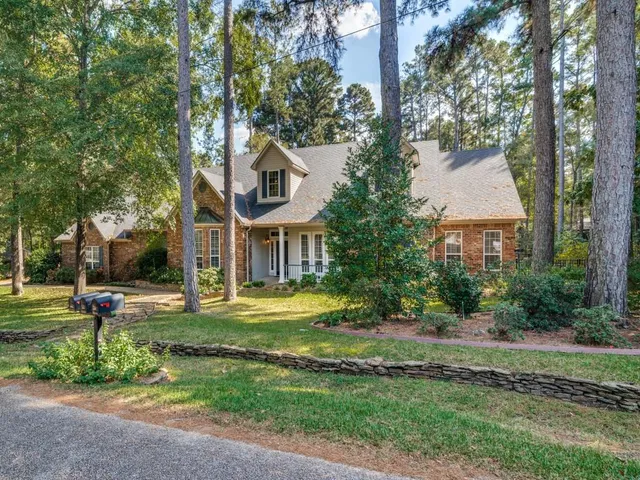 a front view of a house with a yard garage and outdoor seating