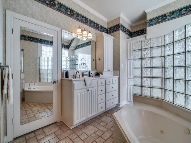 a bathroom with a tub sink and mirror