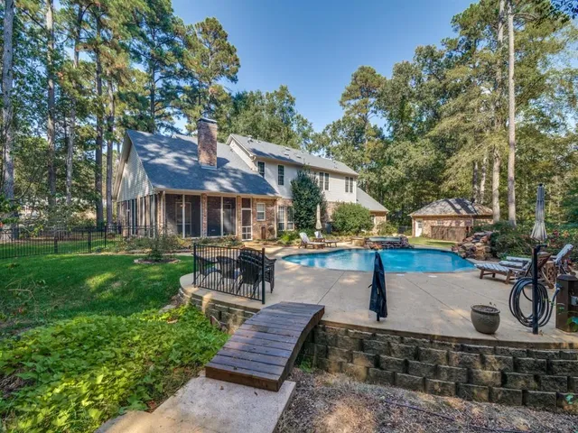 a front view of a house with garden and sitting area