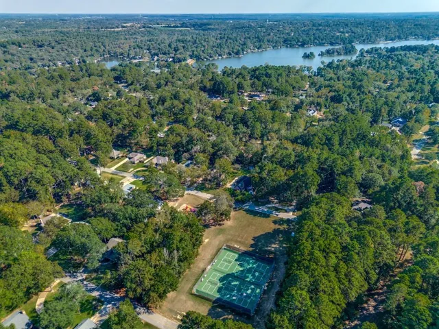 an aerial view of a houses with a yard