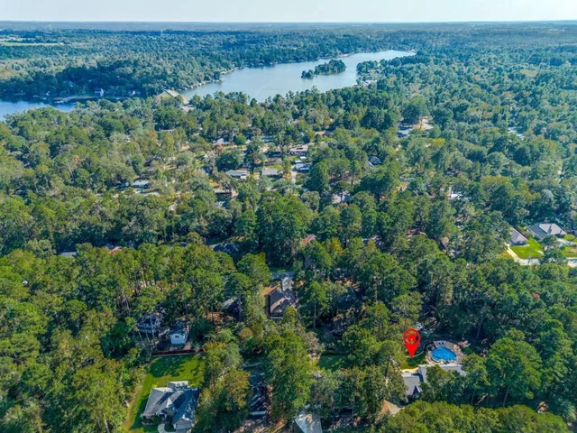an aerial view of a houses with a lush green hillside