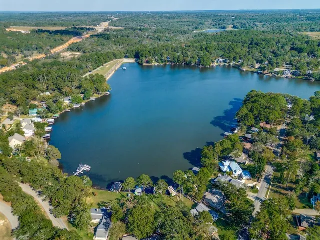 an aerial view of a houses with a lake view