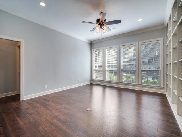 a view of room with wooden floor and fan