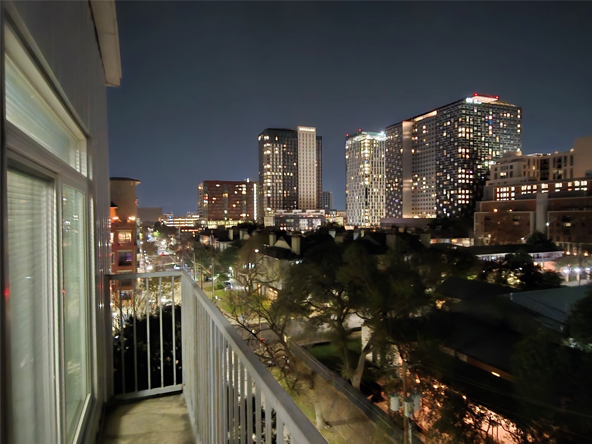 Balcony at night with a view of city lights