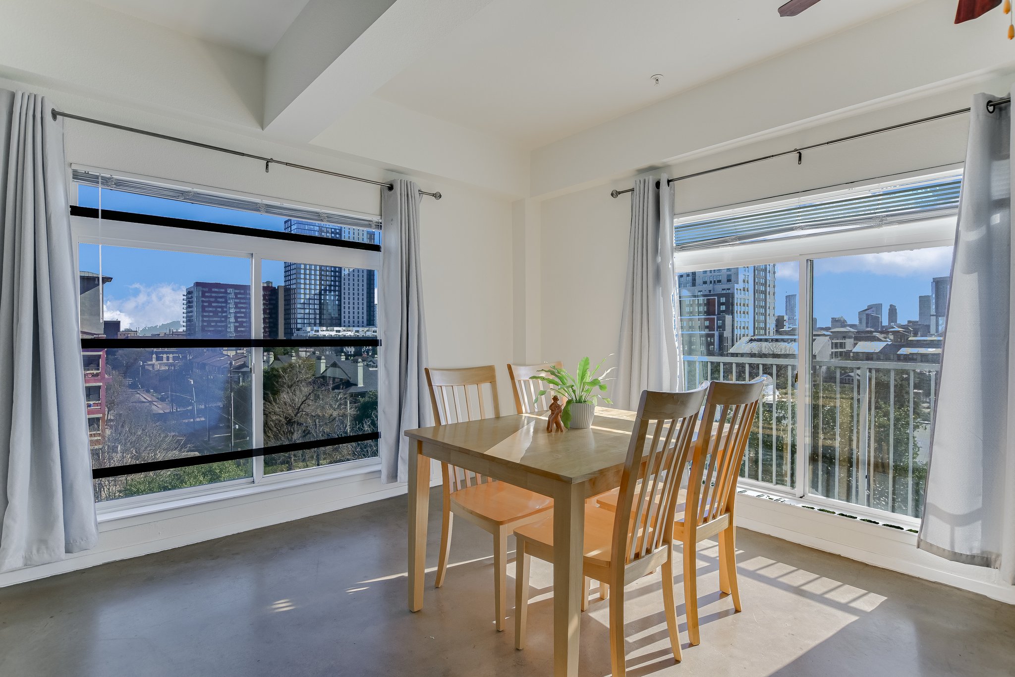 910 West 25th Street, Unit 607 Austin, TX 78705 - Photo 5 of 19 Dining area with a city view and finished concrete flooring
