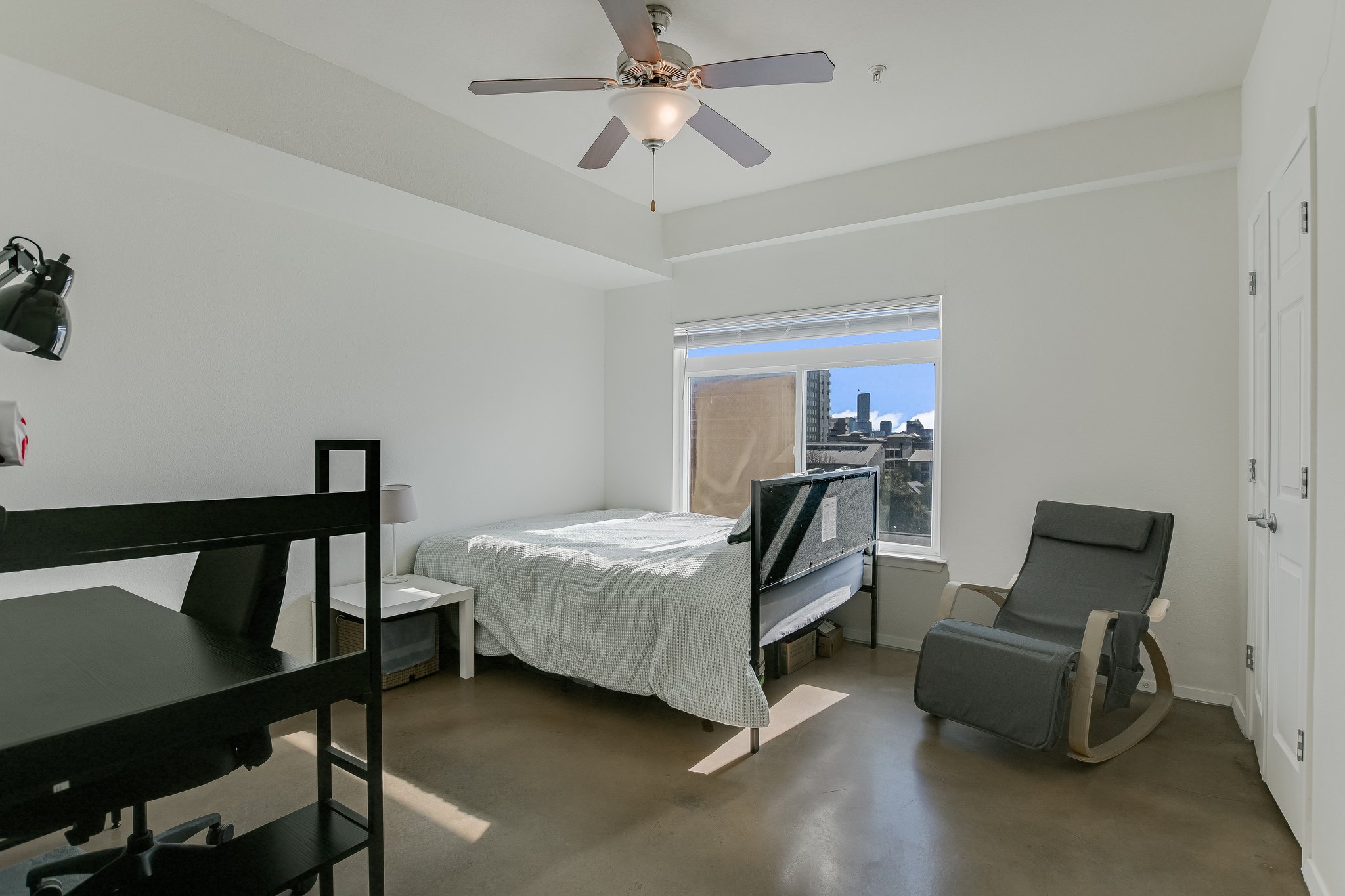 910 West 25th Street, Unit 607 Austin, TX 78705 - Photo 8 of 19 Bedroom featuring concrete flooring and ceiling fan