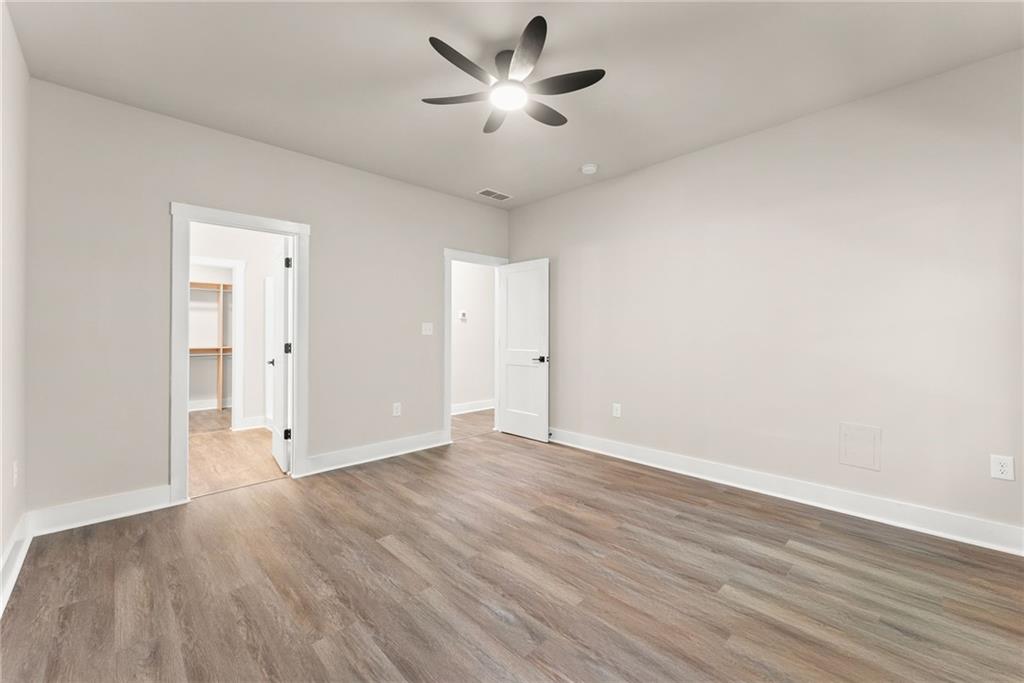 43 Anderson Street Jefferson, GA 30549 - Photo 19 of 45 an empty room with wooden floor and a ceiling fan