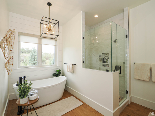 3167 South Mapleton Estates Drive Mapleton, UT 84664 - Photo 13 of 42 Bathroom with a shower stall, wood finished floors, a soaking tub, and a chandelier