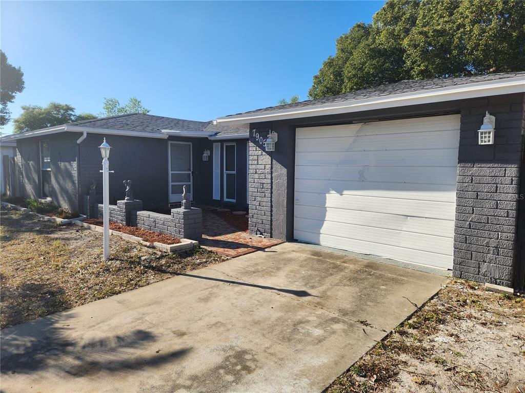 7905 Ironbark Drive Port Richey, FL 34668 - Photo 1 of 1 a front view of a house with a yard