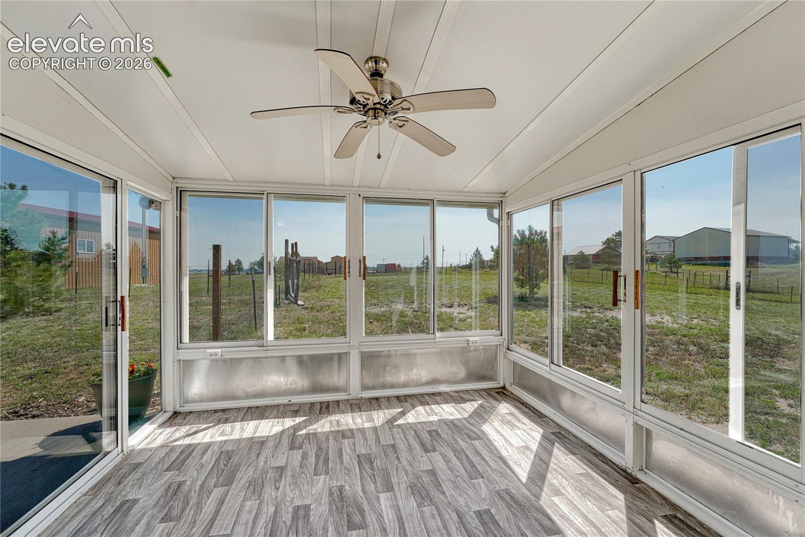 13695 Woodlake Road Elbert, CO 80106 - Photo 13 of 39 ...enclosed sunroom and backyard access.