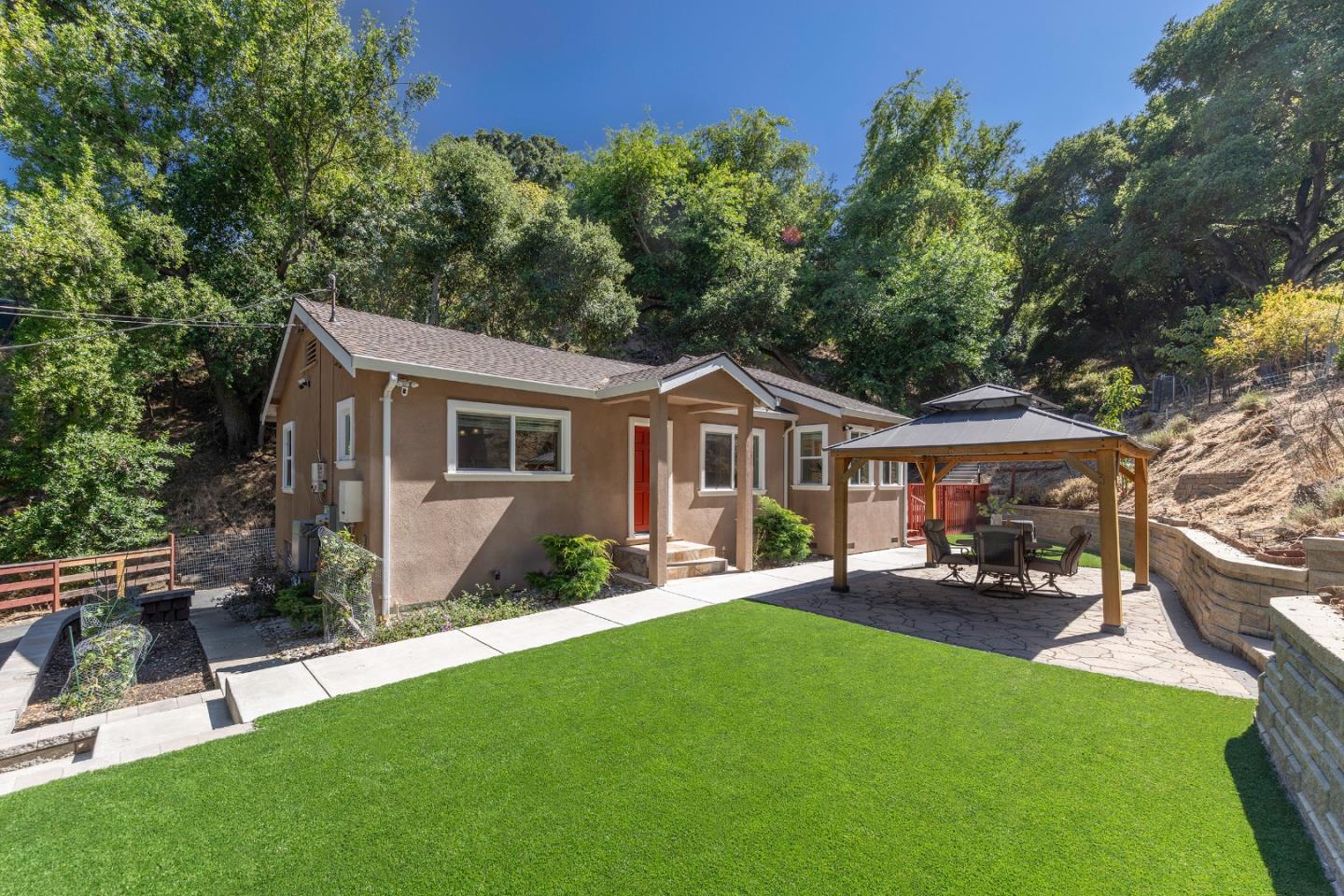 a front view of a house with a yard porch and sitting area