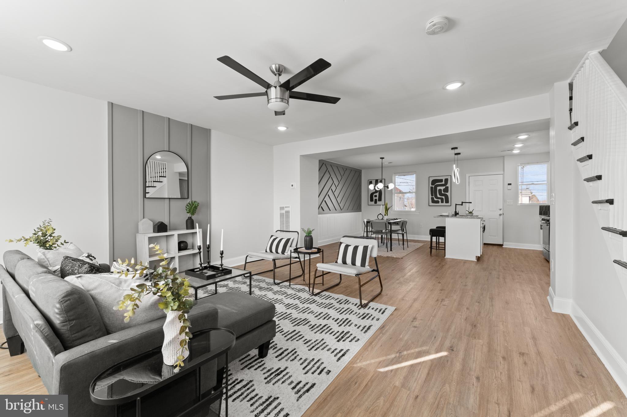 a living room with furniture and wooden floor