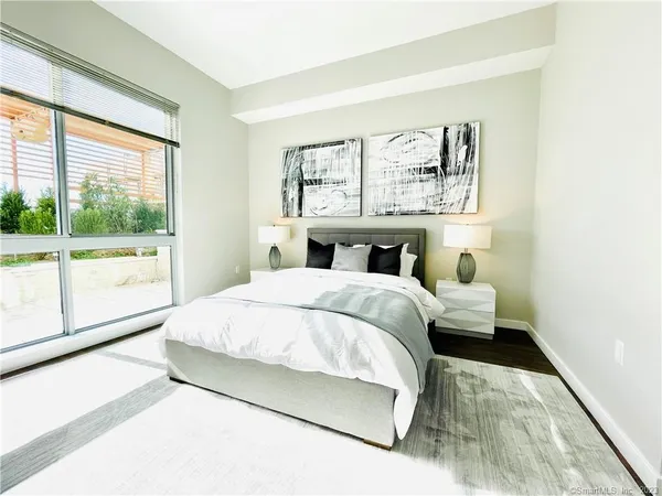 a bedroom with a large bed and a large window