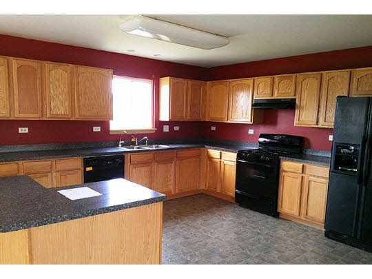 216 Ridgestone Trail Poplar Grove, IL 61065 - Photo 4 of 11 a kitchen with stainless steel appliances kitchen island granite countertop a sink a stove top oven a counter space and cabinets