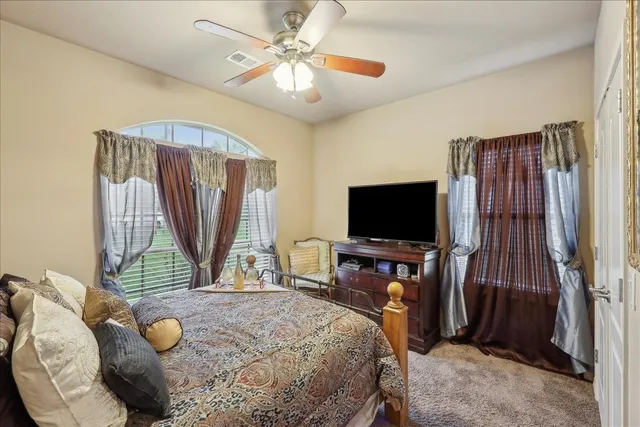 a bedroom with a bed and a flat screen tv