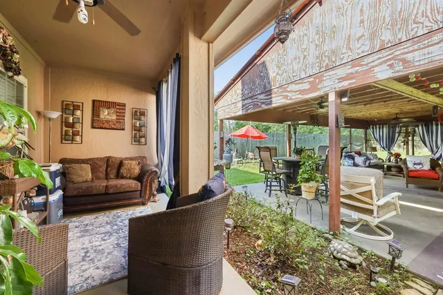 a outdoor living space with patio furniture and potted plants