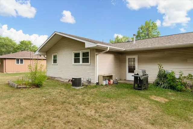 a backyard of a house with table and chairs