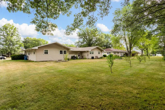 a house view with swimming pool in front of it