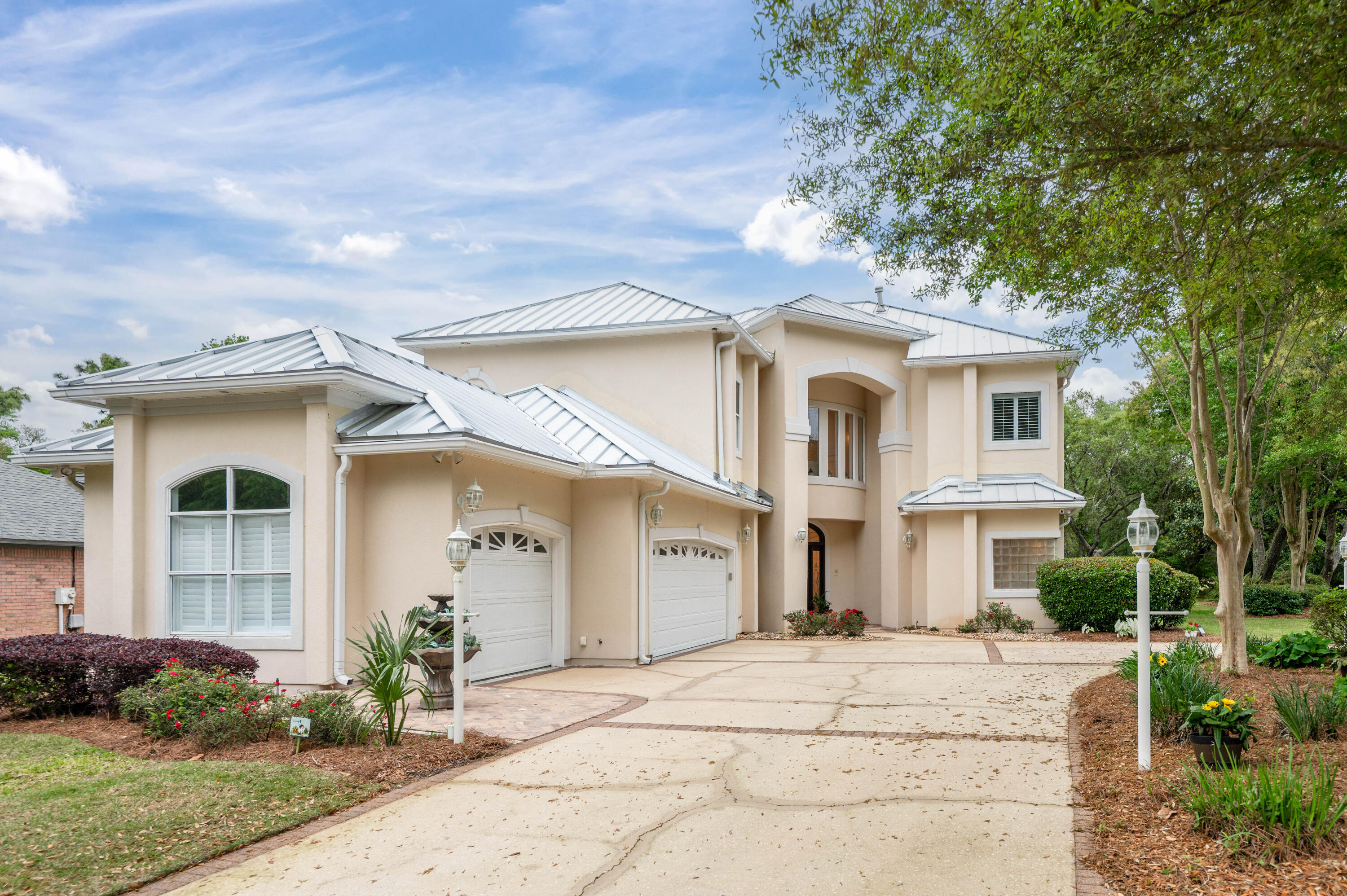 1325 Windrush Cove Niceville, FL 32578 - Photo 3 of 70 a front view of a house with a garden and outdoor seating
