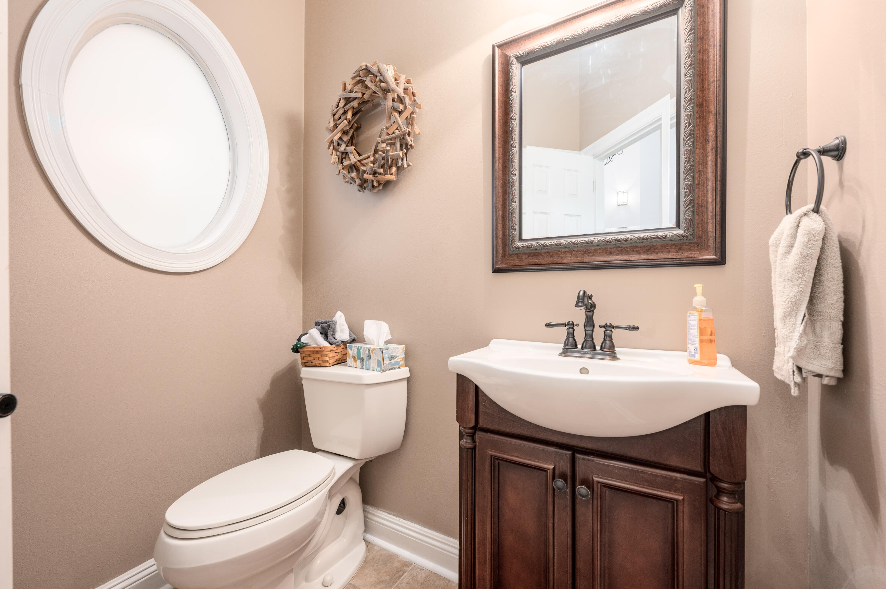 1325 Windrush Cove Niceville, FL 32578 - Photo 59 of 70 a bathroom with a toilet a sink and a mirror