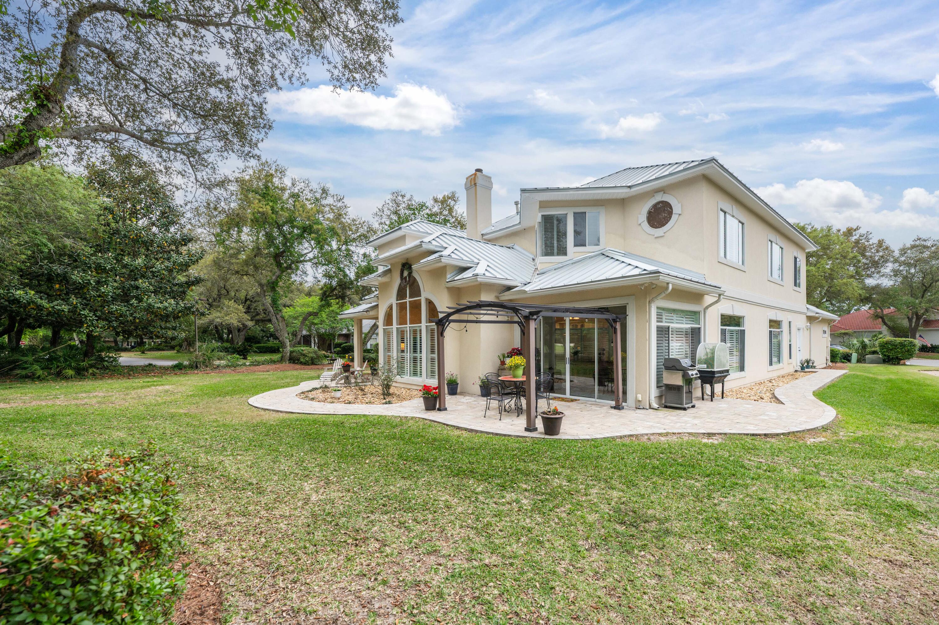 1325 Windrush Cove Niceville, FL 32578 - Photo 62 of 70 a front view of a house with garden and porch