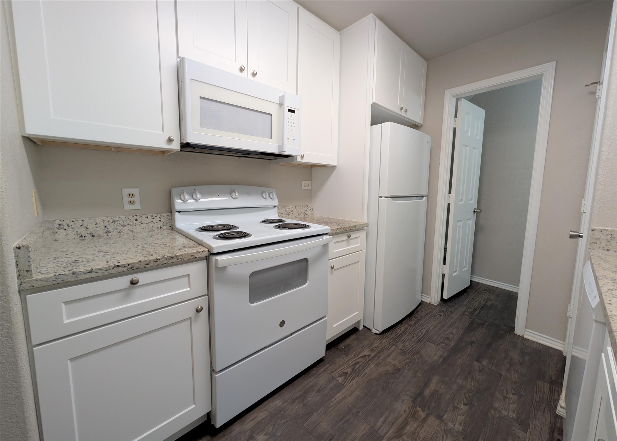 8816 Schick Road, Unit D Austin, TX 78729 - Photo 6 of 19 Kitchen has Quartz Counters and White Appliances/Cabinets