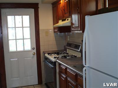 1019 Spring Street Bethlehem, PA 18018 - Photo 11 of 27 a kitchen with a stove and a refrigerator