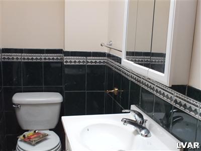 1019 Spring Street Bethlehem, PA 18018 - Photo 21 of 27 a bathroom with a sink a toilet and a mirror