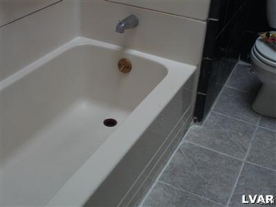 1019 Spring Street Bethlehem, PA 18018 - Photo 22 of 27 a bathroom with a tub