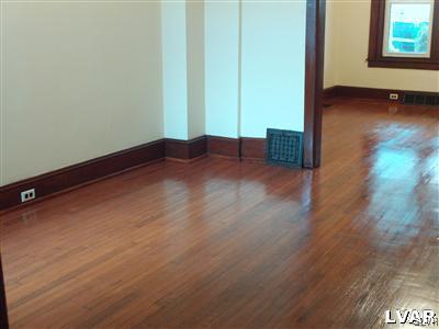 1019 Spring Street Bethlehem, PA 18018 - Photo 9 of 27 an empty room with wooden floor and windows